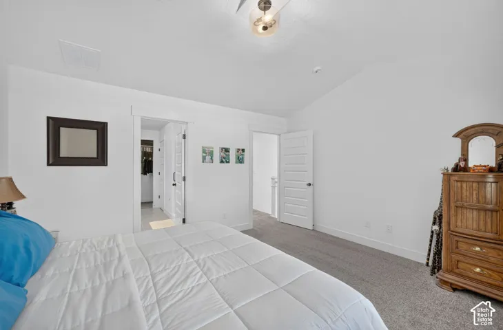 Angled ceiling, recessed lighting, ceiling fan light fixture, sliding barn door, paneled interior doors