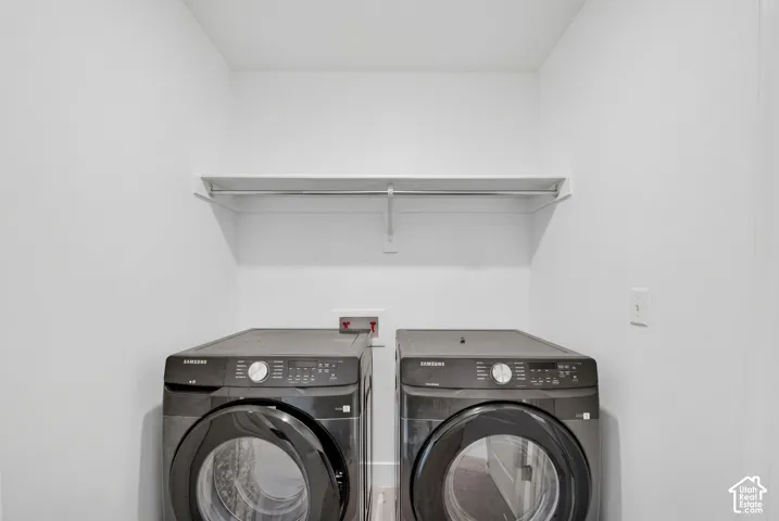 Utility area featuring a wall-mounted shelf and white walls
