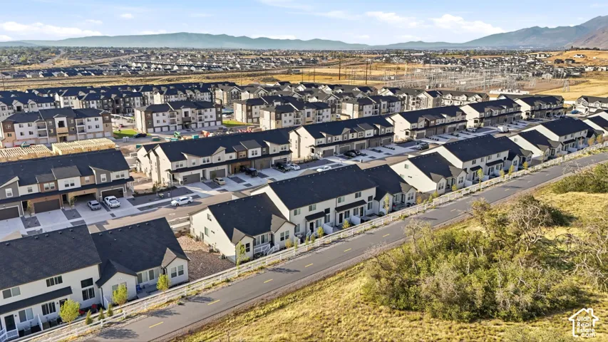 Multiple residential buildings with dark roofs and light-colored siding