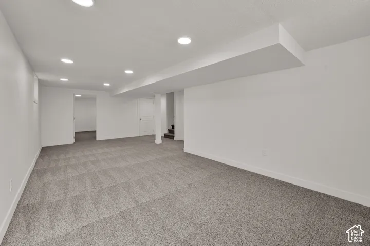 Expansive finished lower level featuring recessed lighting and neutral gray carpeting