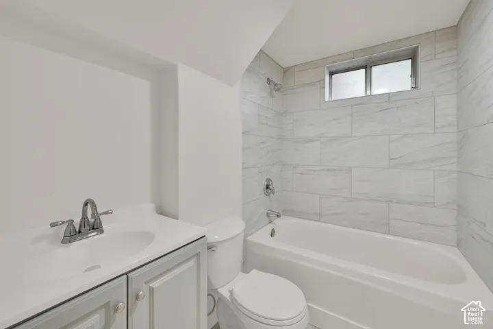 White vanity with chrome faucet, integrated sink, and panel-front cabinetry