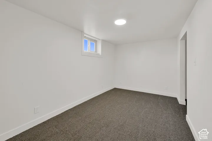 Recessed lighting, white walls, and gray carpeting