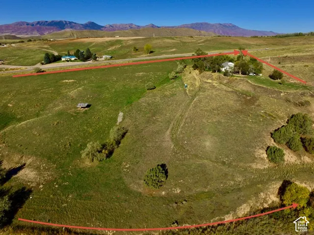 Expansive rural property with rolling terrain and distant mountain ranges