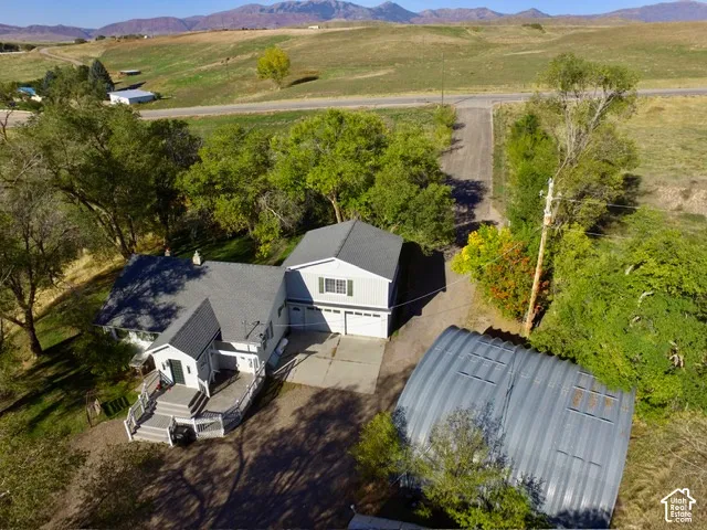 Attached two-car garage, multiple gabled roofs, and a large deck with multiple levels