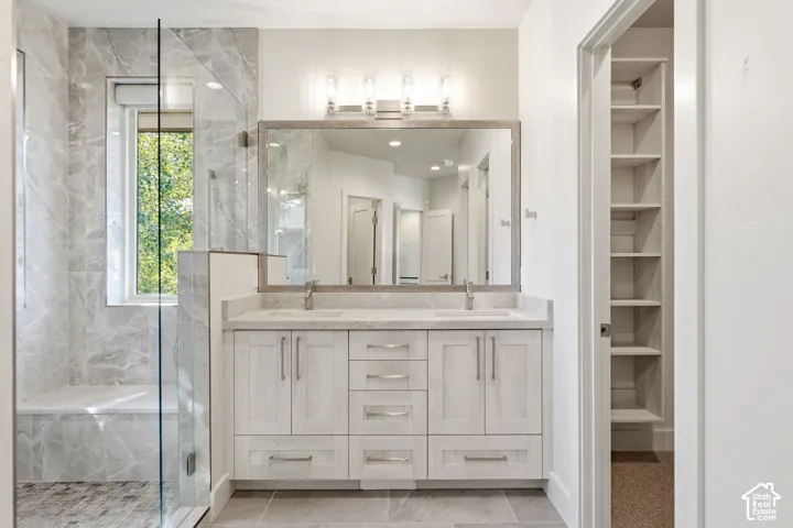 Dual vanity with integrated sinks, framed mirror, and contemporary light fixture