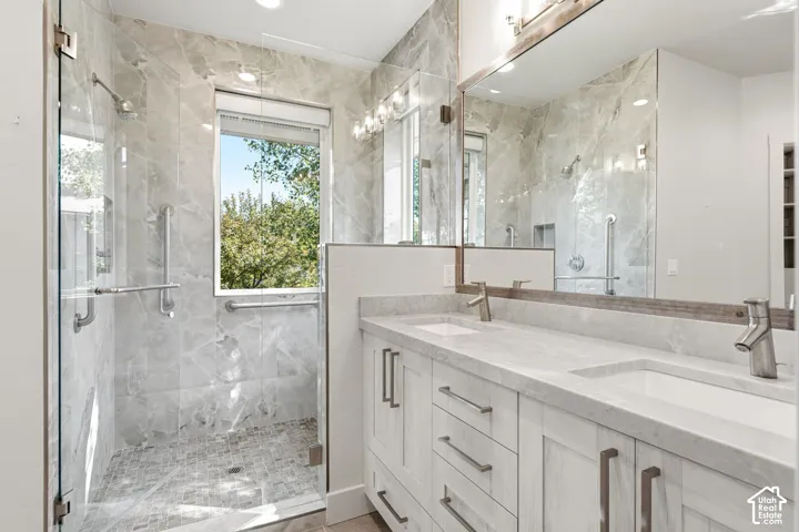 Dual vanity with integrated sinks, brushed nickel faucets, and a large framed mirror