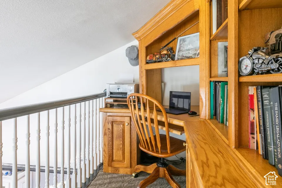 Built-in oak desk with integrated shelving, providing dedicated workspace and storage