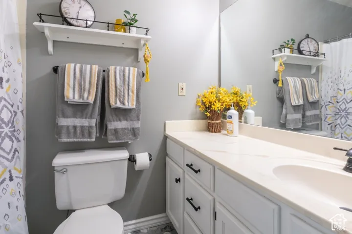 White vanity with black pulls, light-toned countertop, and integrated sink