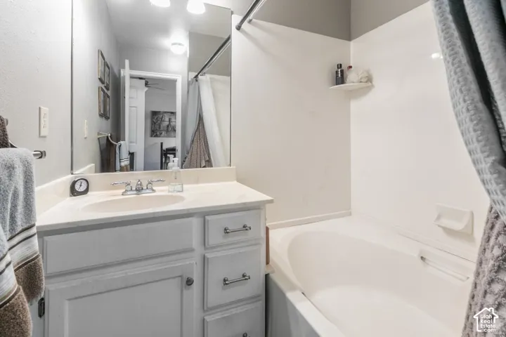 Single vanity with built-in sink, chrome faucet, and under-sink storage