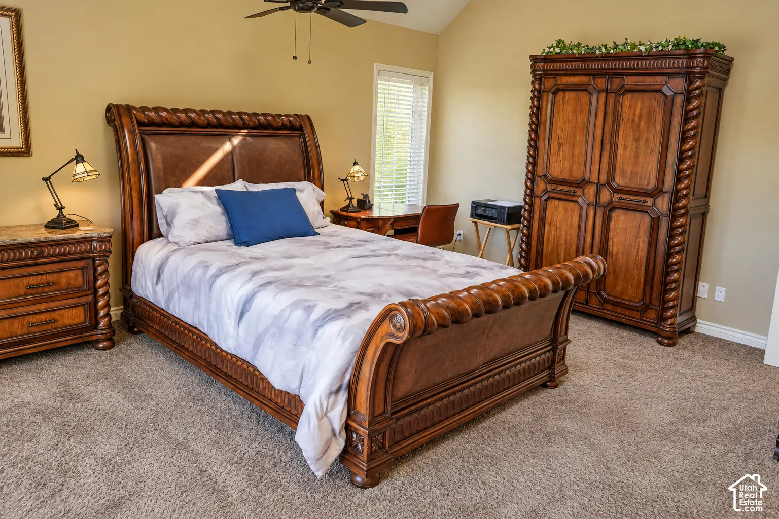 Carpeted flooring with sloped ceiling, and a ceiling fan with light fixture