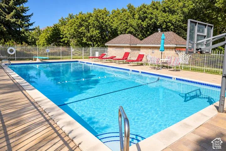 Resort-style swimming pool featuring crystal-clear water, lane dividers for lap swimming, and a sun deck with lounge seating