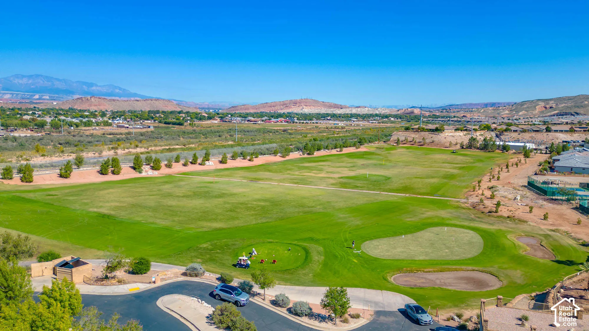 Expansive golf course setting featuring manicured greens and natural desert landscaping