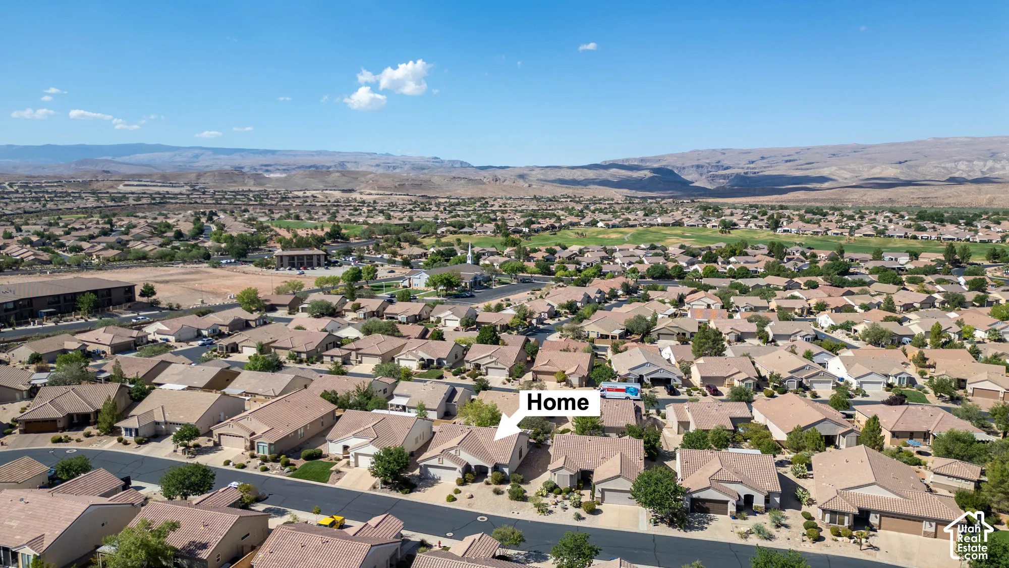 Residential community with arid landscaping and distant mountain backdrop