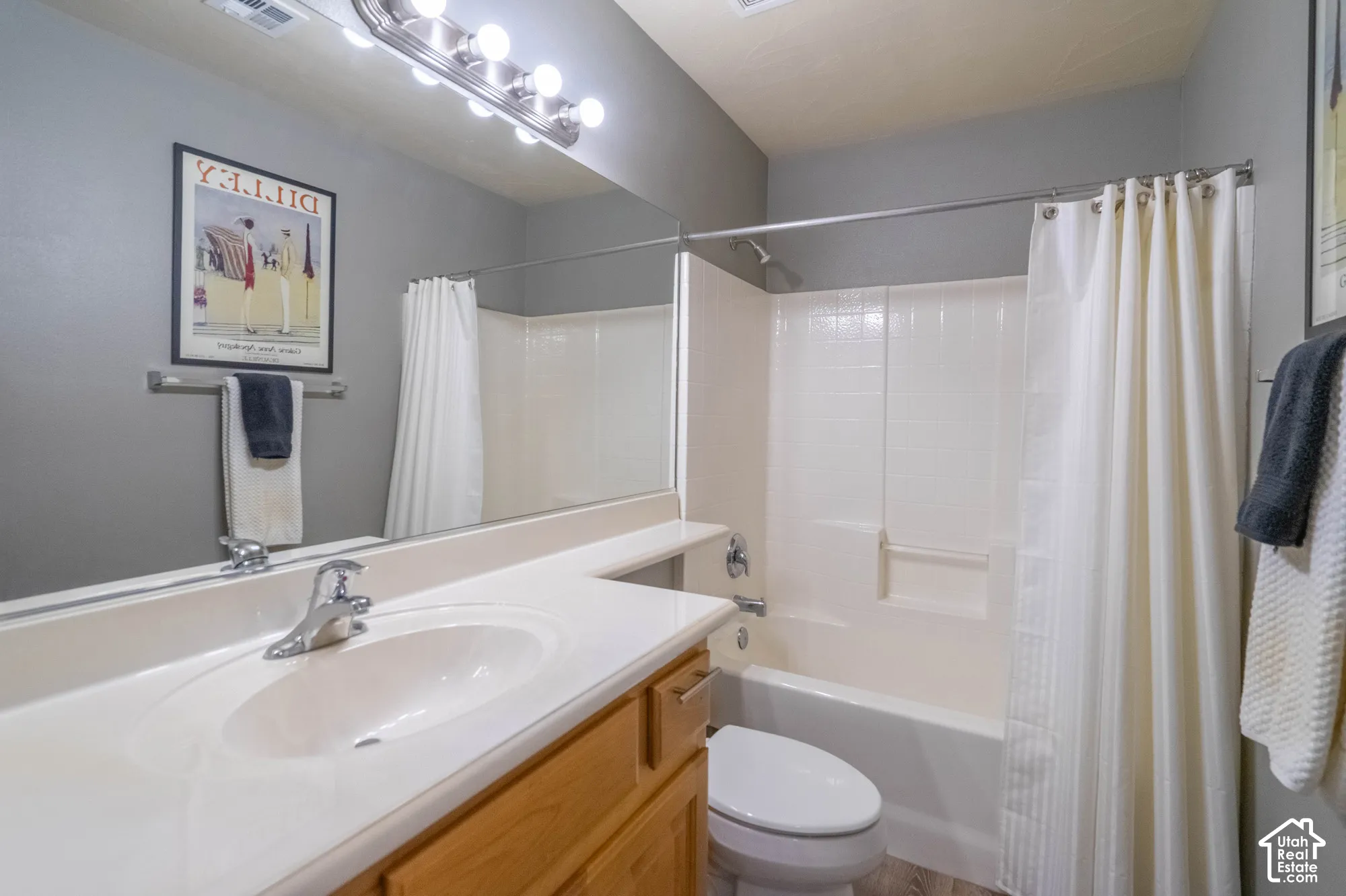 2nd Bathroom featuring a single vanity with integrated sink, wood-finish cabinetry, full-width mirror, and a shower-tub combination