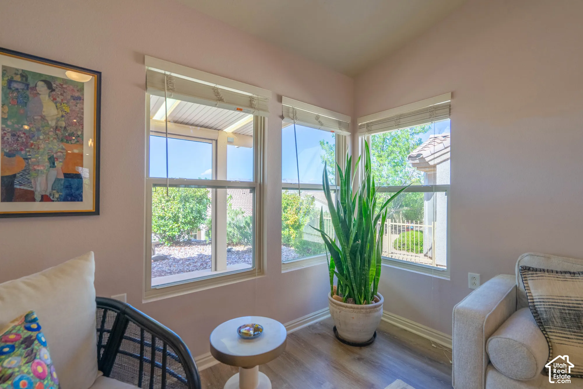 Corner window placement, wood-finish flooring, white trim, and light wall tones. NEW Windows and Views out back