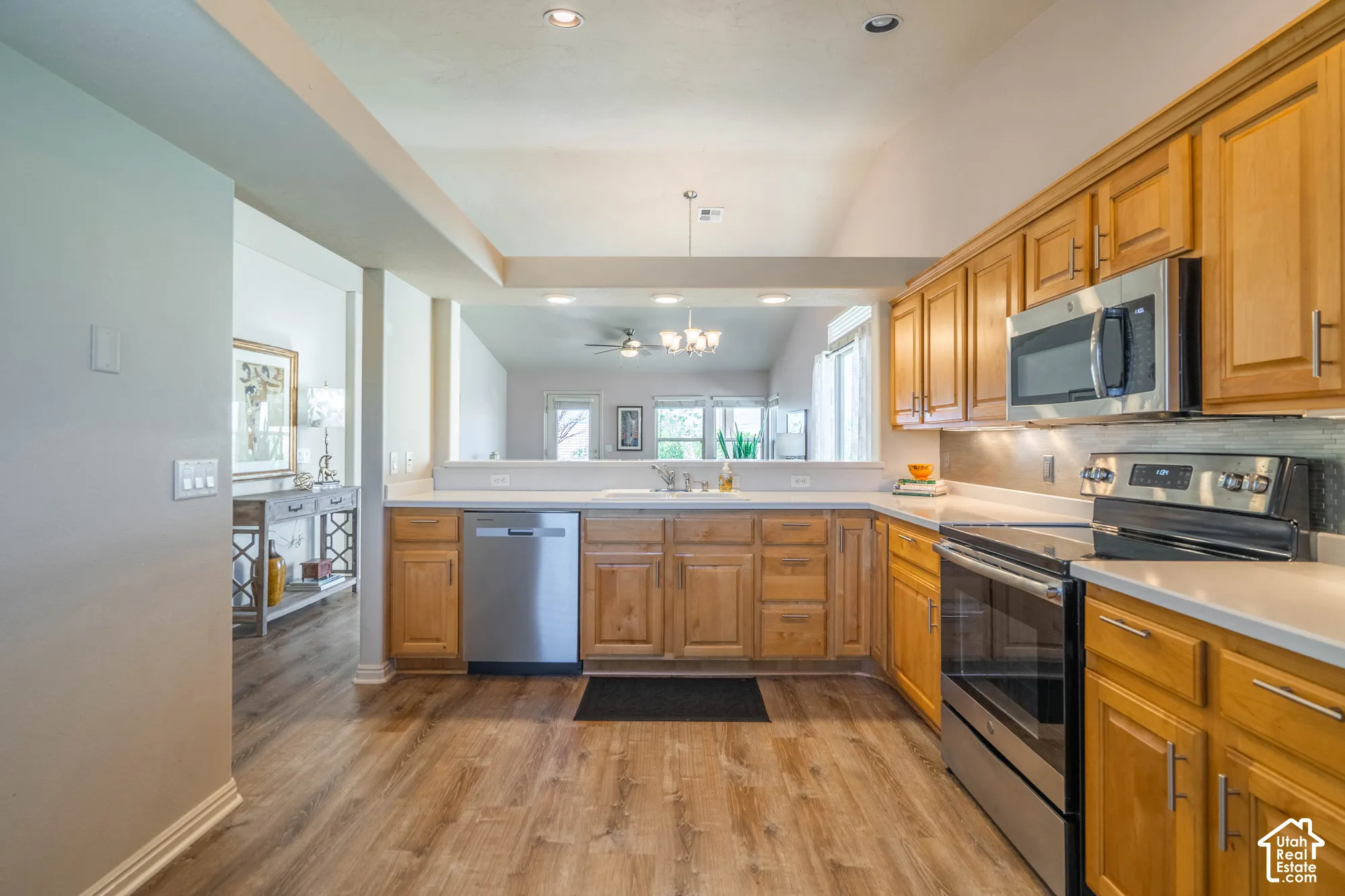 Wood-finish LVP flooring throughout, complemented by alder cabinetry with brushed nickel hardware