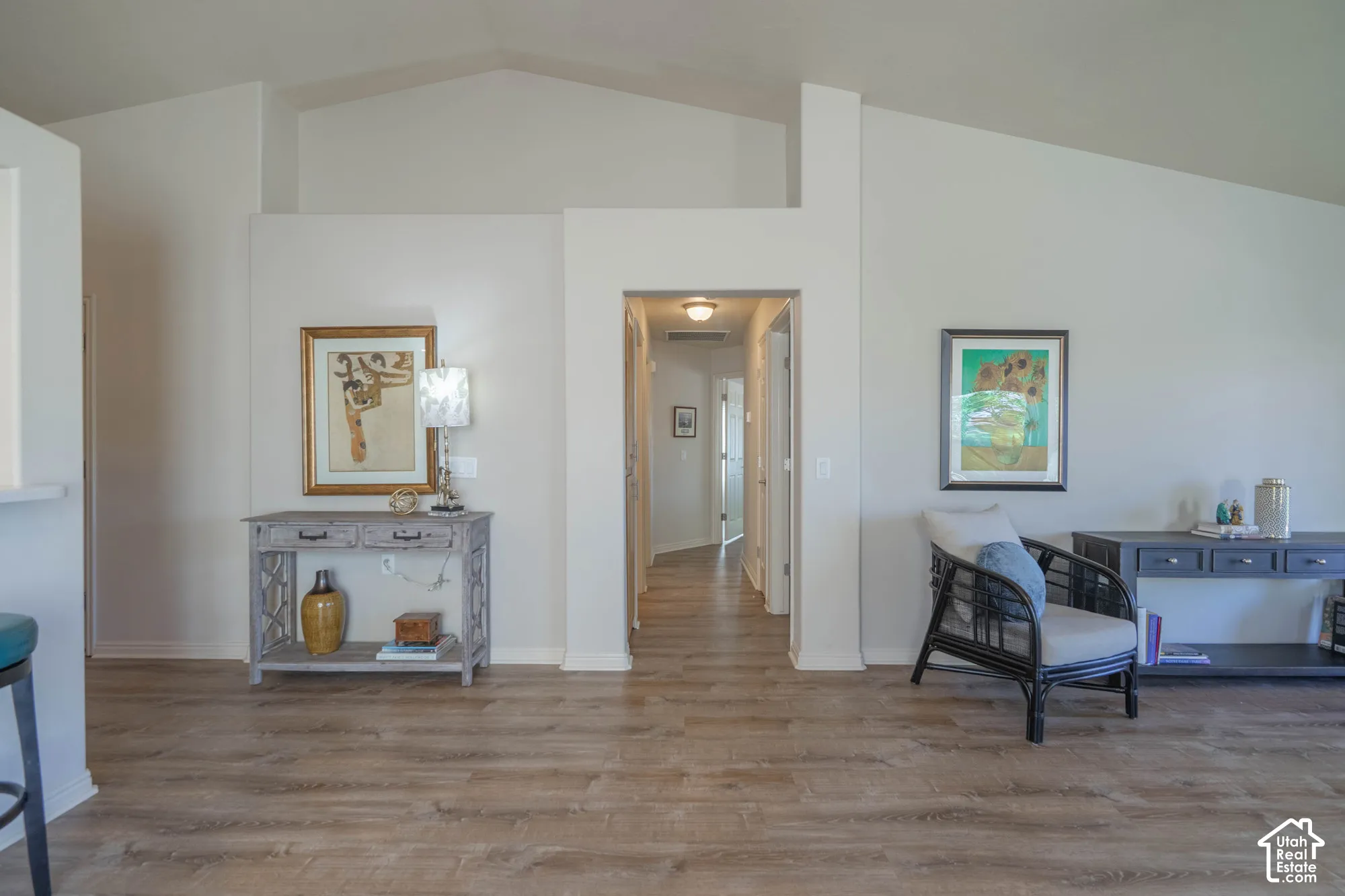 Vaulted ceilings, wood-finish flooring, and recessed lighting.  Hallway to Bedrooms
