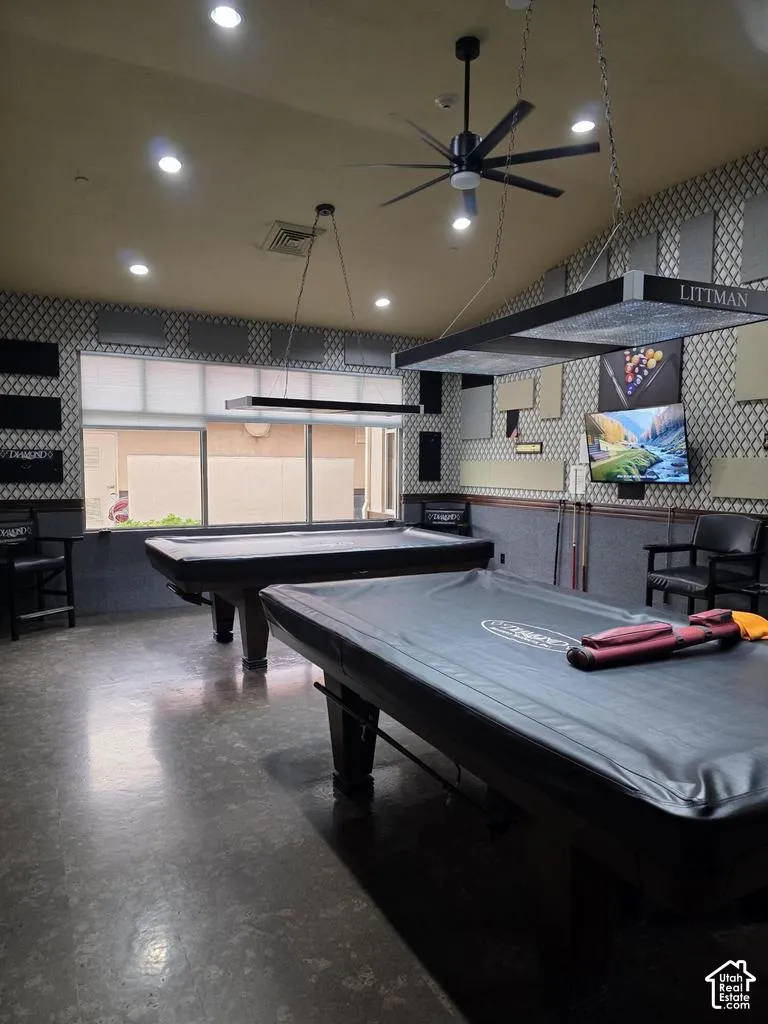 Recreation room featuring two pool tables, recessed ceiling lighting, a contemporary ceiling fan, and large windows