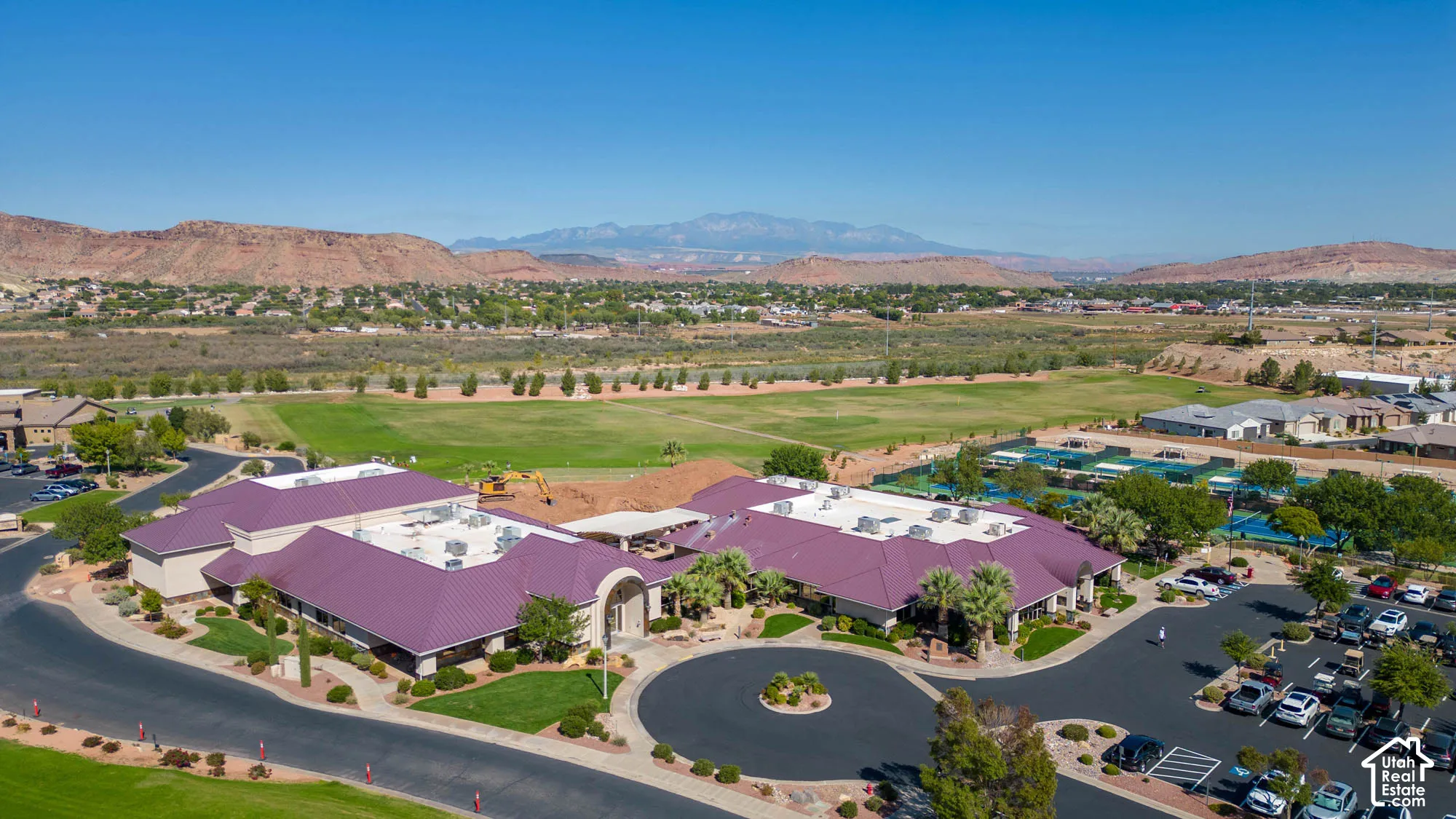 Multi-structure complex with expansive parking, landscaping, and a circular driveway