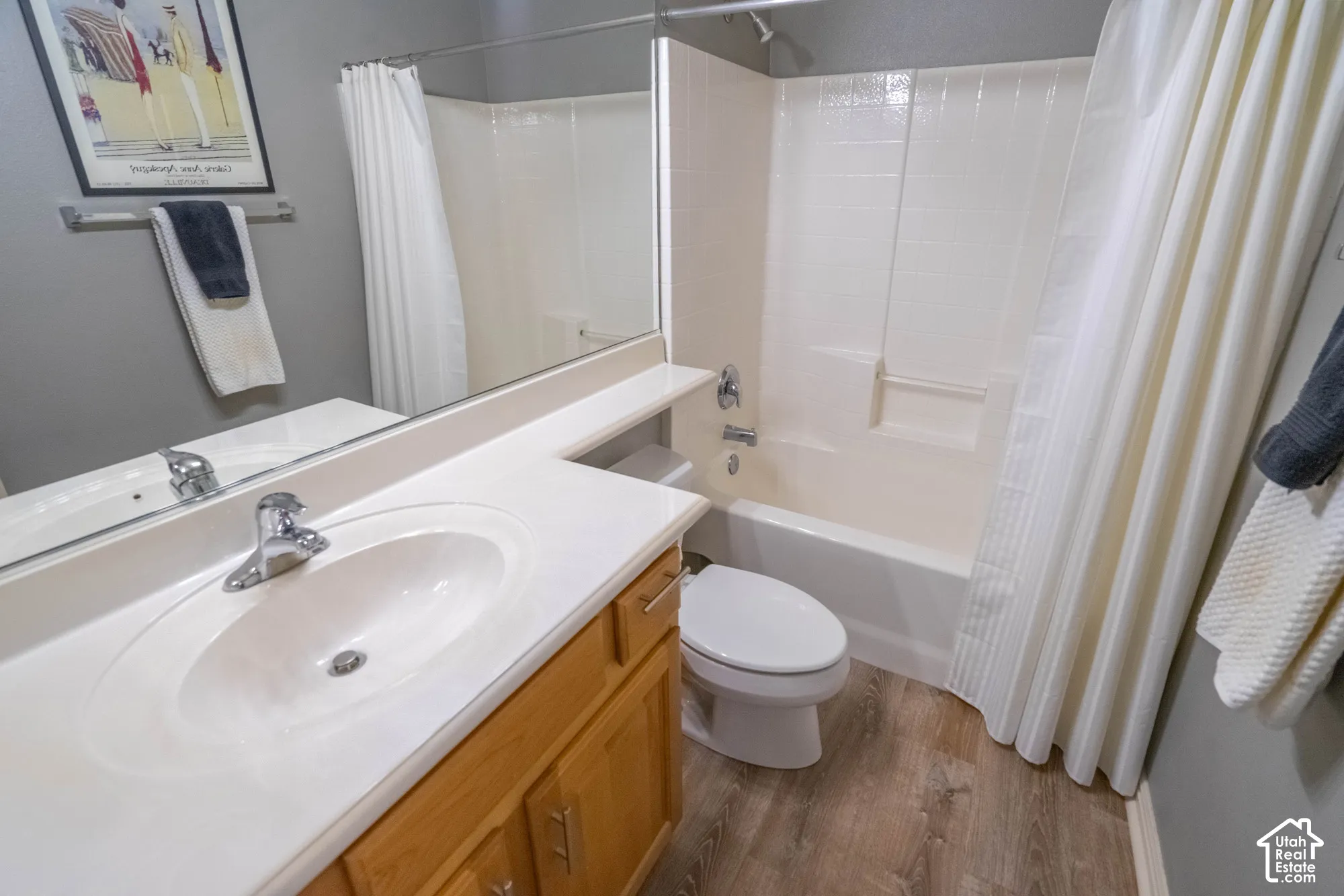 2nd Bathroom featuring a vanity with an integrated sink, chrome faucet, and wood-finish cabinetry