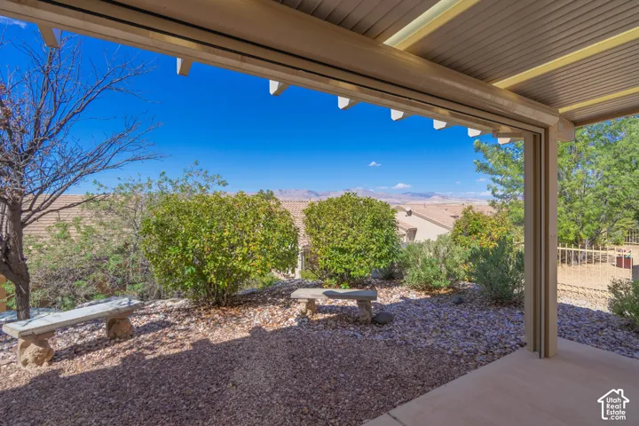 Covered patio featuring a solid roof and supportive columns. and VIEWS of mountain
