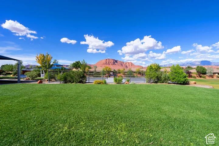 Expansive green lawn with mountain backdrop