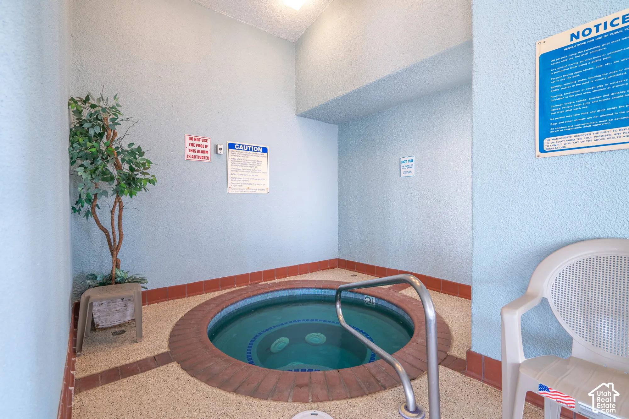 Built-in circular spa with brick surround and metal handrail
