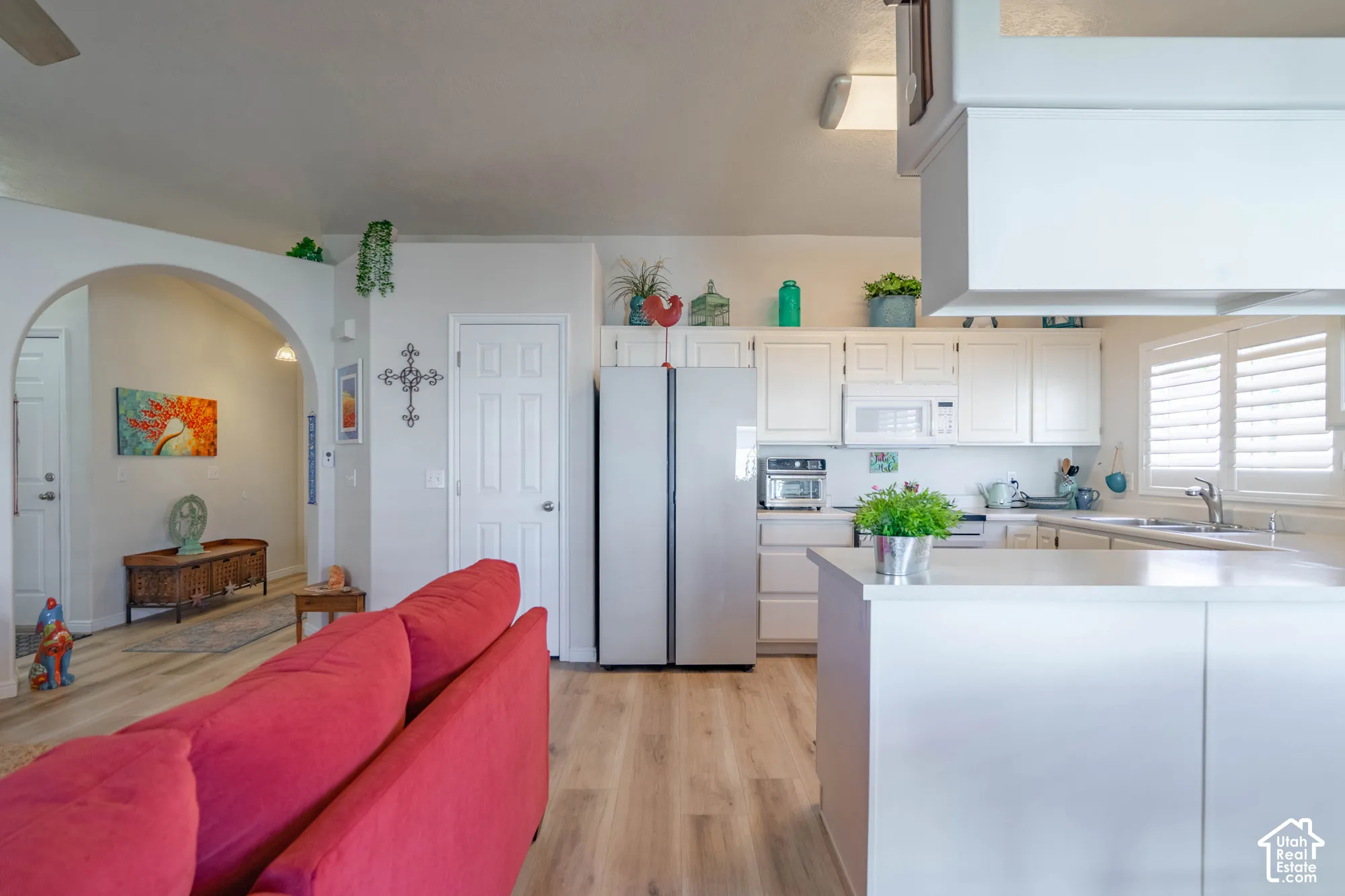 Kitchen featuring white cabinetry, light countertops, and a stainless steel refrigerator
