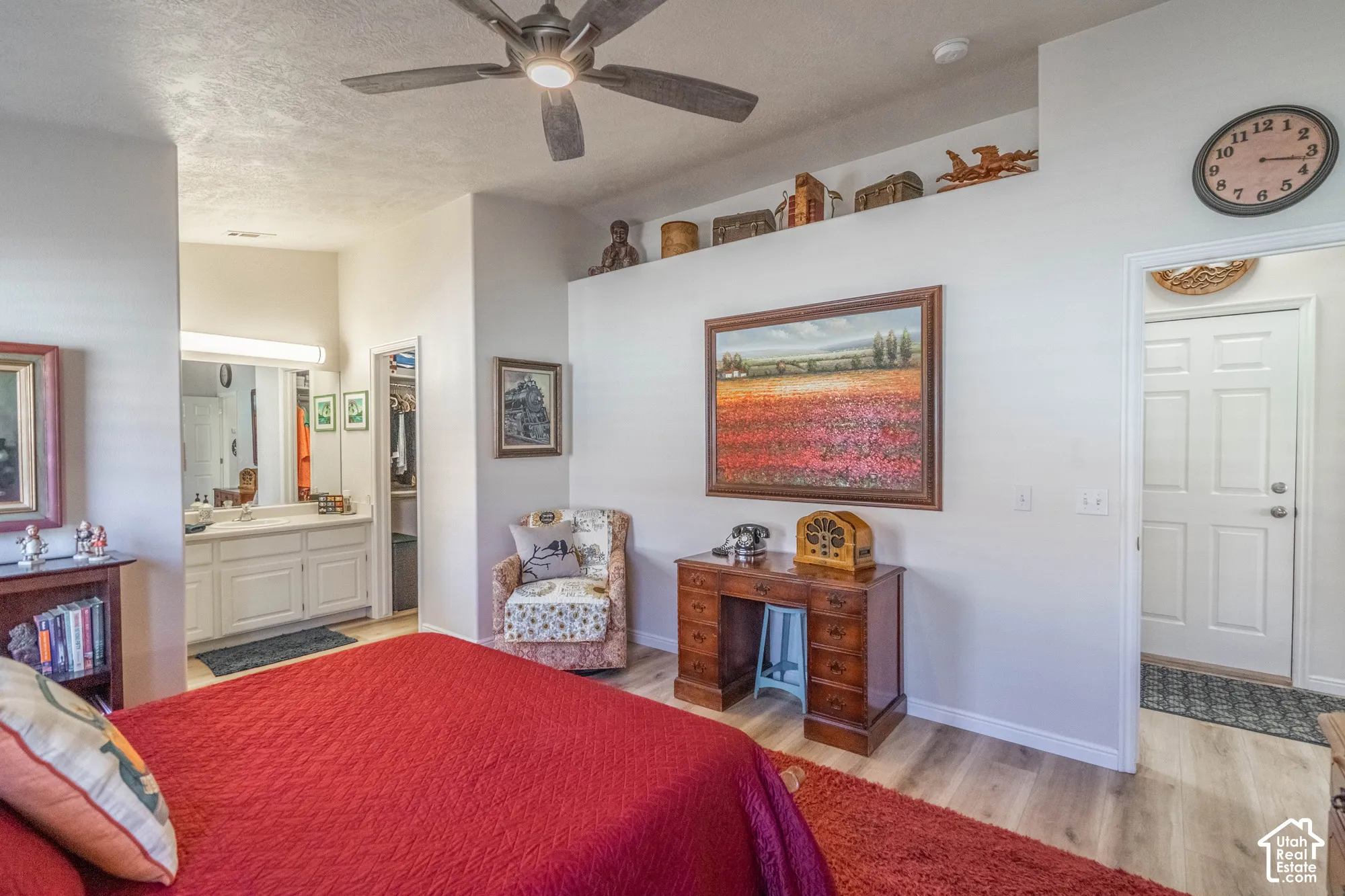 Wood-finish flooring throughout, with a ceiling fan featuring integrated lighting