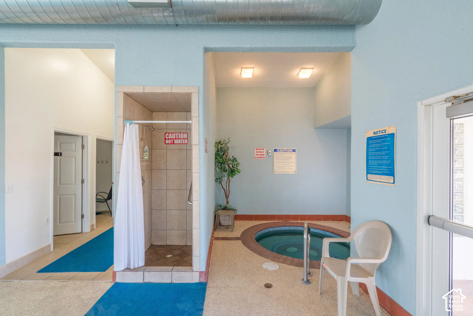 Tiled shower stall with an integrated showerhead and a built-in hot tub