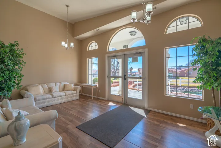 Wood-finish flooring with high ceilings, featuring transom windows and glass panel doors