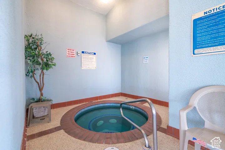 Built-in circular spa with brick surround and metal handrail