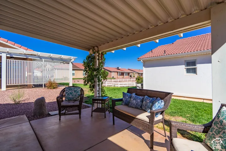 Covered patio featuring a solid roof structure and concrete flooring