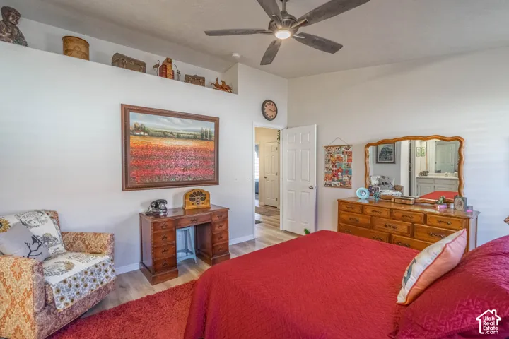 Recessed ceiling shelf, wood-finish flooring, and a ceiling fan with integrated lighting