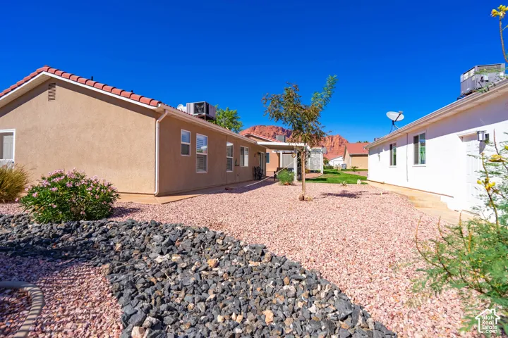 Drought-tolerant landscaping featuring diverse rock beds and mature plantings