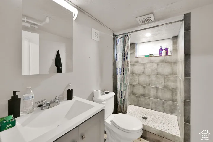 Modern bathroom featuring a clean-lined vanity with integrated sink, quartz countertop, and matte black hardware