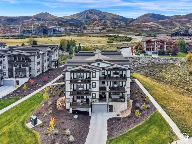Modern multi-story building featuring stone accents and private balconies