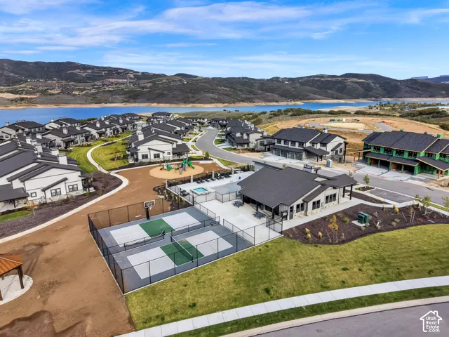 Community featuring a clubhouse, outdoor pool, and sports courts