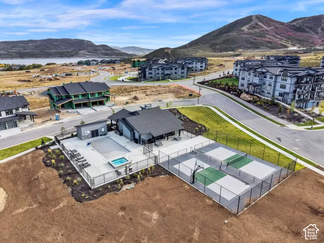 Community amenities include a fenced swimming pool, spa, and two multi-sport courts