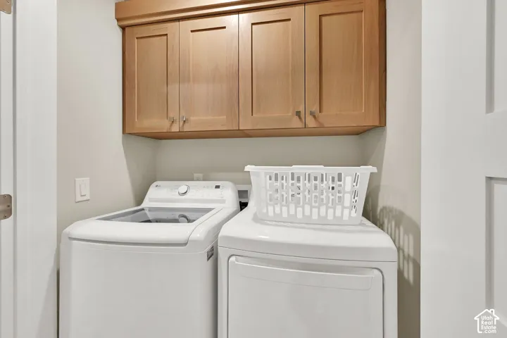 Wood-finish cabinetry with silver hardware provides storage