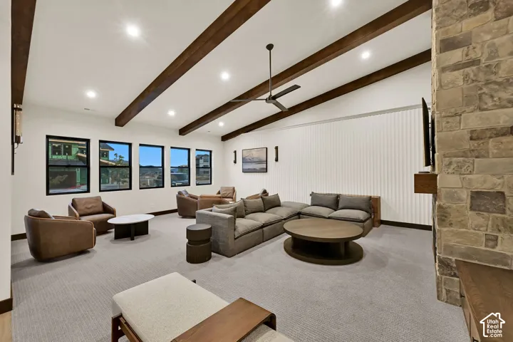 Vaulted ceiling with exposed wood beams, recessed lighting, and a ceiling fan