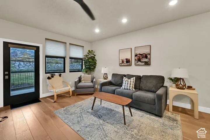 Wood-finish flooring throughout, recessed lighting, and a full-light exterior door