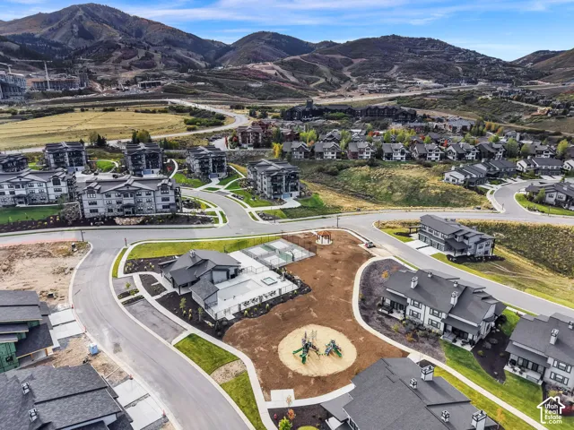 Community featuring residential buildings, paved streets, and mountainous terrain