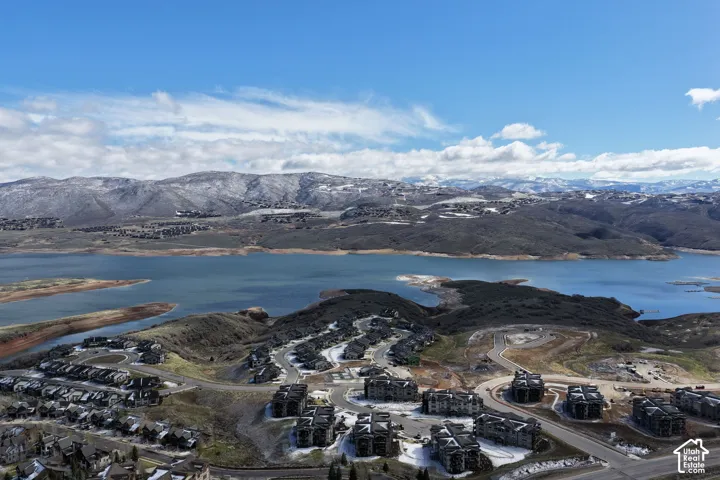 Expansive development with mountain and lake background