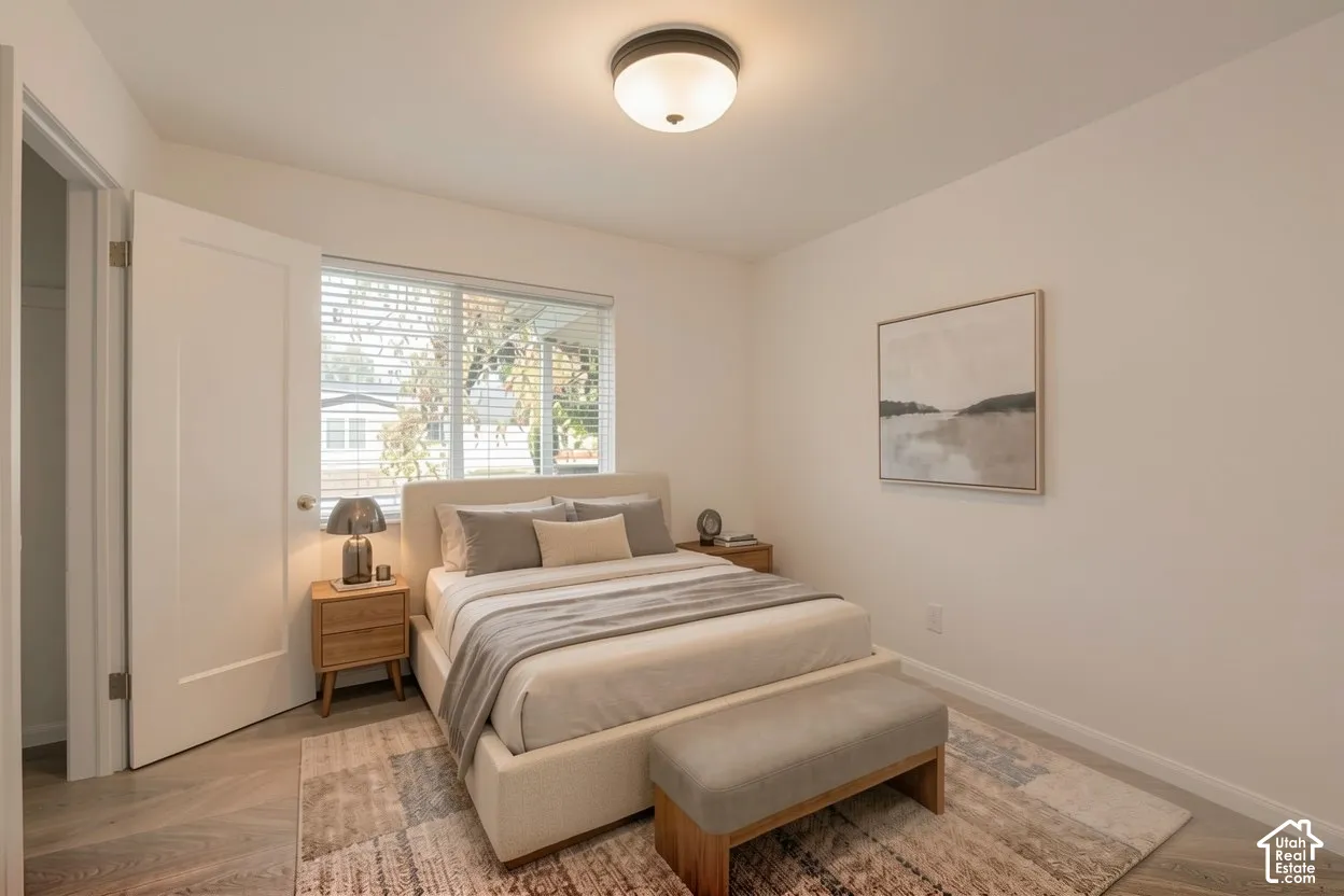 Recessed window with blinds, wood-finish flooring, and a flush-mount ceiling light fixture