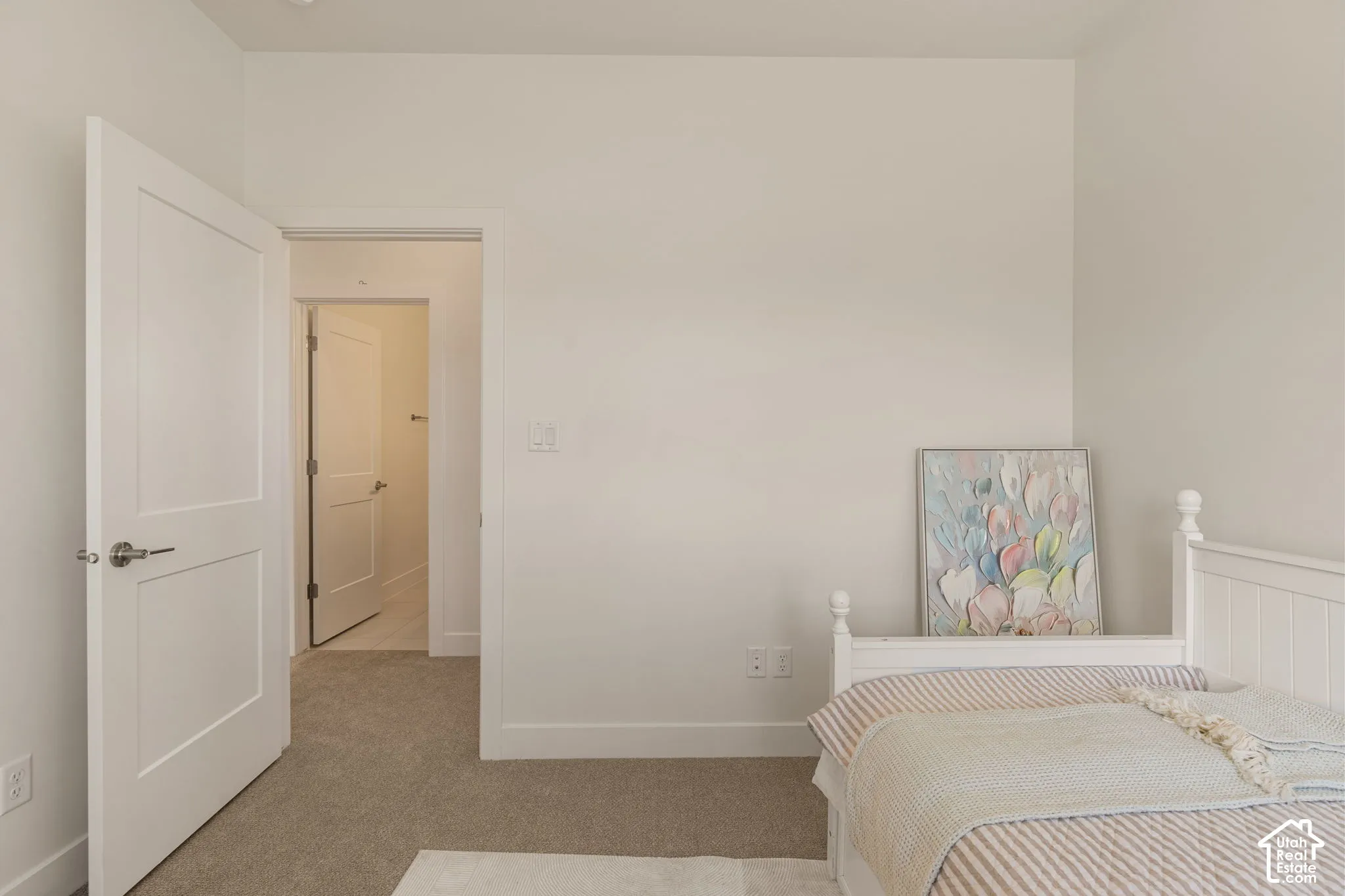 Clean wall surfaces, recessed lighting, white interior doors, and neutral carpeting