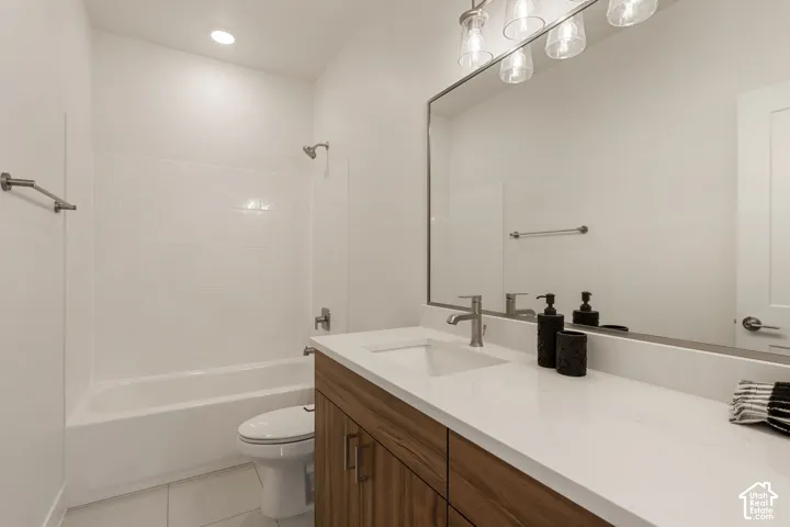 Modern bathroom featuring a wood-finish vanity with dual sink layout, white quartz countertop, and polished chrome faucetry