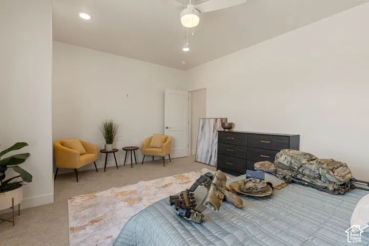 Spacious primary bedroom with neutral wall finishes, recessed ceiling lighting, and a ceiling fan