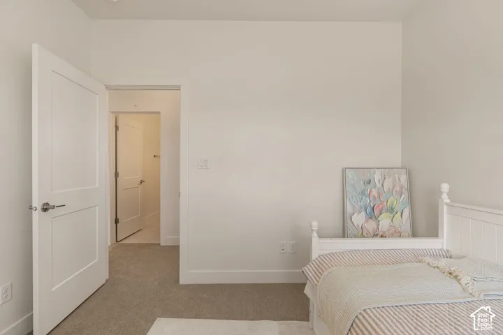 Clean wall surfaces, recessed lighting, white interior doors, and neutral carpeting