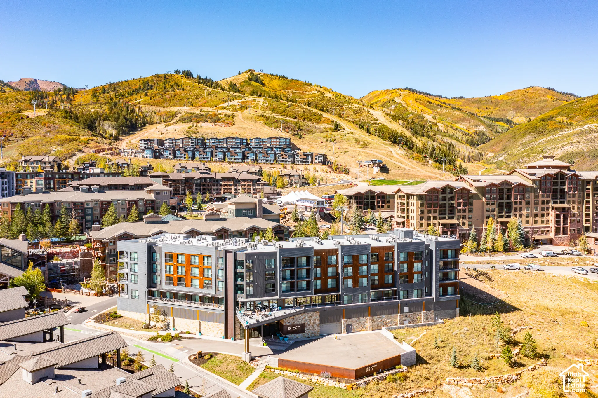 Multi-story building featuring a modern facade with mixed materials, including wood-tone panels and gray siding